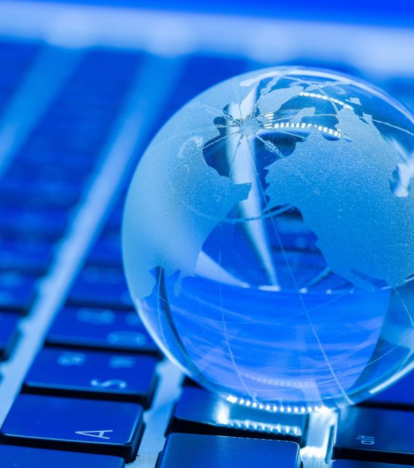 The business concept of the glass world on a laptop keyboard