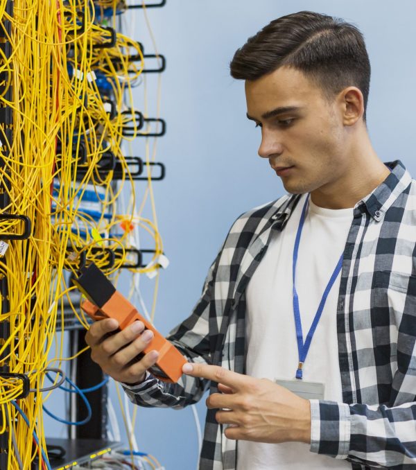 young-man-looking-fiber-optic-tester-medium-shot