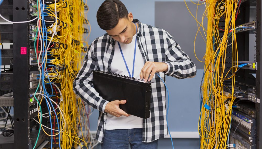 young-network-engineer-holding-ethernet-switches